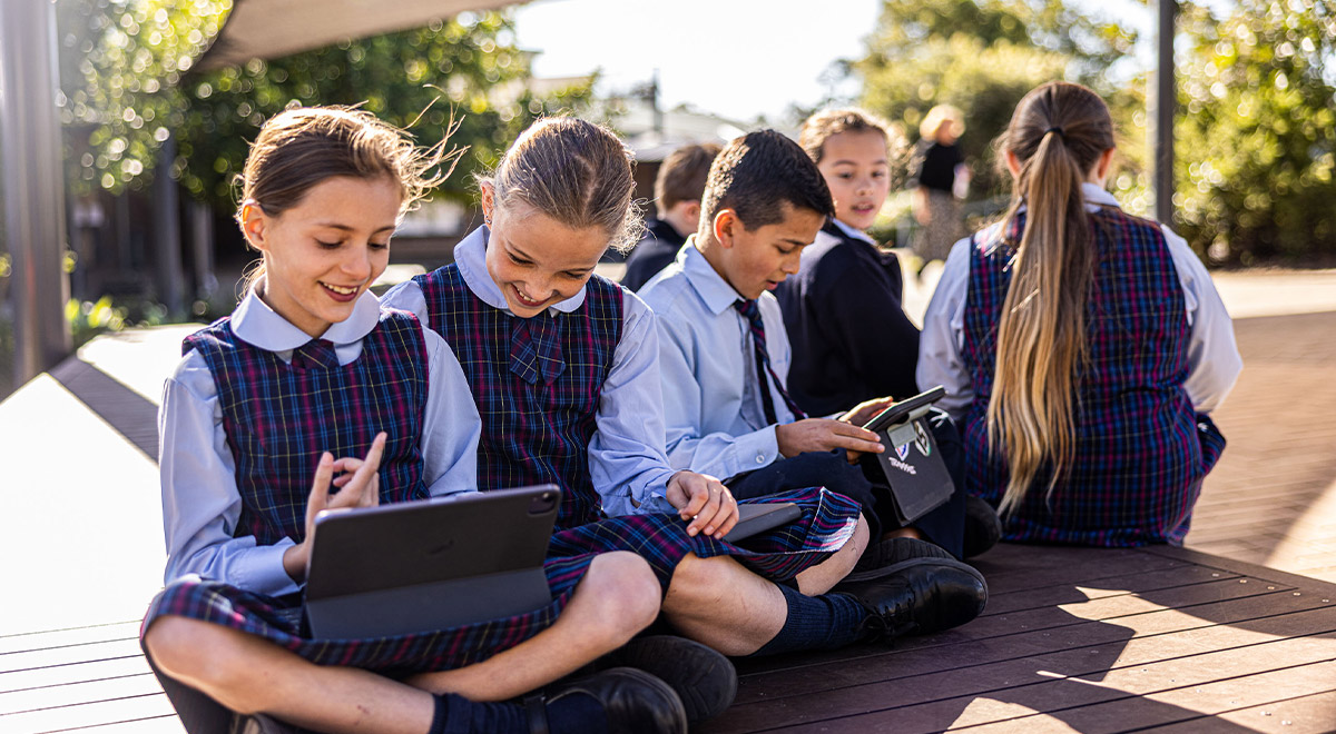 Students sitting in sun at St Madeleine's Catholic Primary School Kenthurst