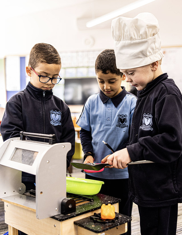 Students inside play kitchen at St Madeleine's Catholic Primary School Kenthurst