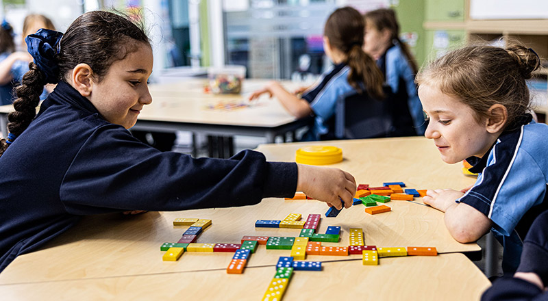 Students play with dominoes at St Madeleine's Catholic Primary School Kenthurst