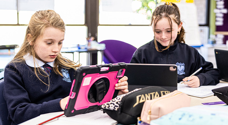 Students smiling on iPad at St Madeleine's Catholic Primary School Kenthurst