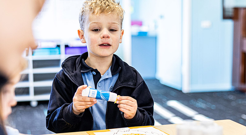 Student with glue stick at St Madeleine's Catholic Primary School Kenthurst