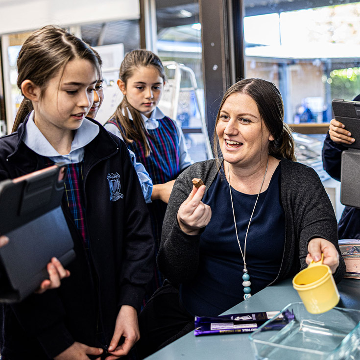 Smiling student and dedicated teacher at St Madeleine's Catholic Primary School Kenthurst