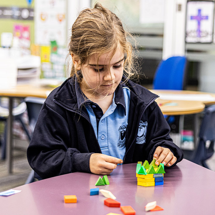 Student plays with maths equipment at St Madeleine's Catholic Primary School Kenthurst