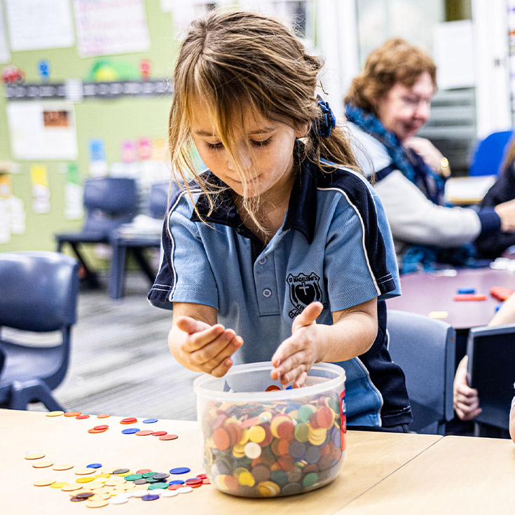 Student holding counters at St Madeleine's Catholic Primary School Kenthurst